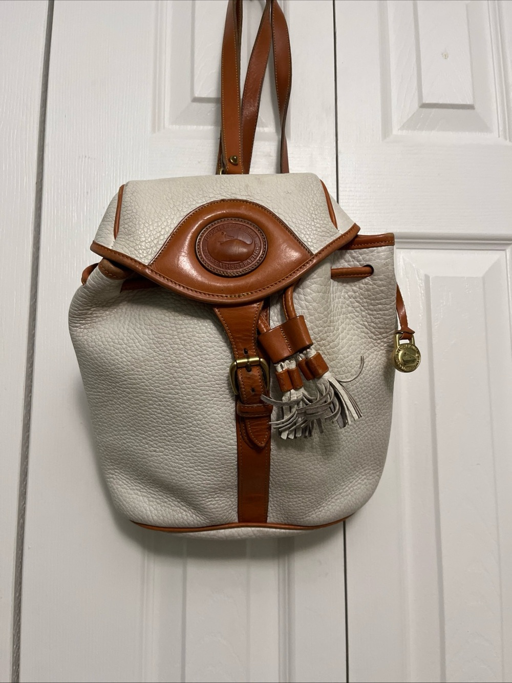 Dooney & Bourke Cream and Tan Leather Drawstring Backpack with Tassel
